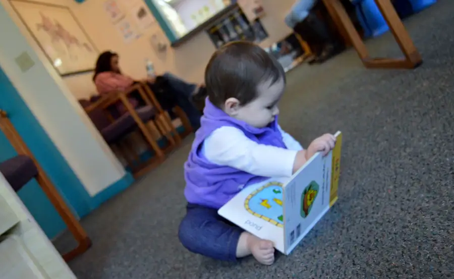 A child plays with a book in the South Royalton Health Center patient waiting room.